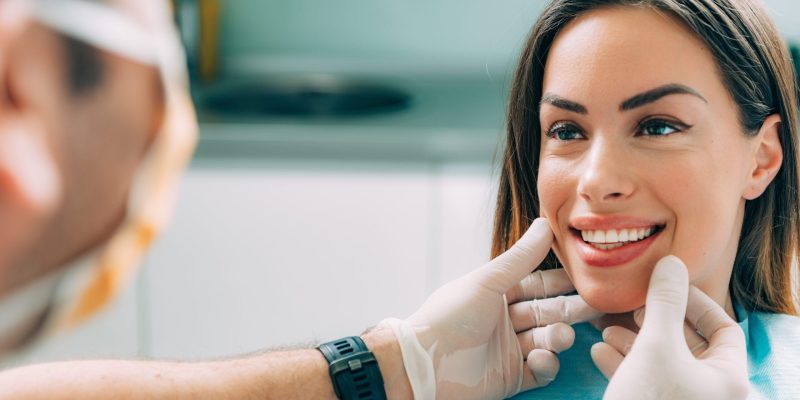 Young,Smiling,Woman,With,Beautifiul,Teeth,,Having,A,Dental,Inspection