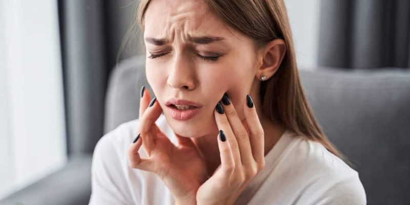 Toothache.,Girl,Suffering,From,Tooth,Pain,And,Touching,Cheek,While