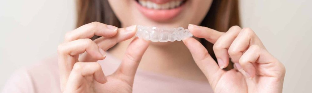 Dental,Invisible,Braces,,Beautiful,Smiling,Asian,Young,Woman,Holding,Invisalign